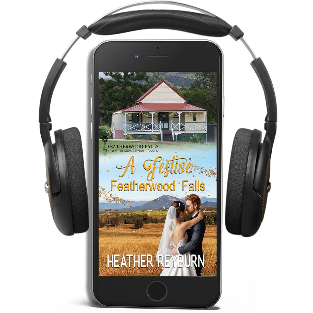 Phone displaying a book cover of 'A Festive Featherwood Falls' by Heather Reyburn with headphones on a white background